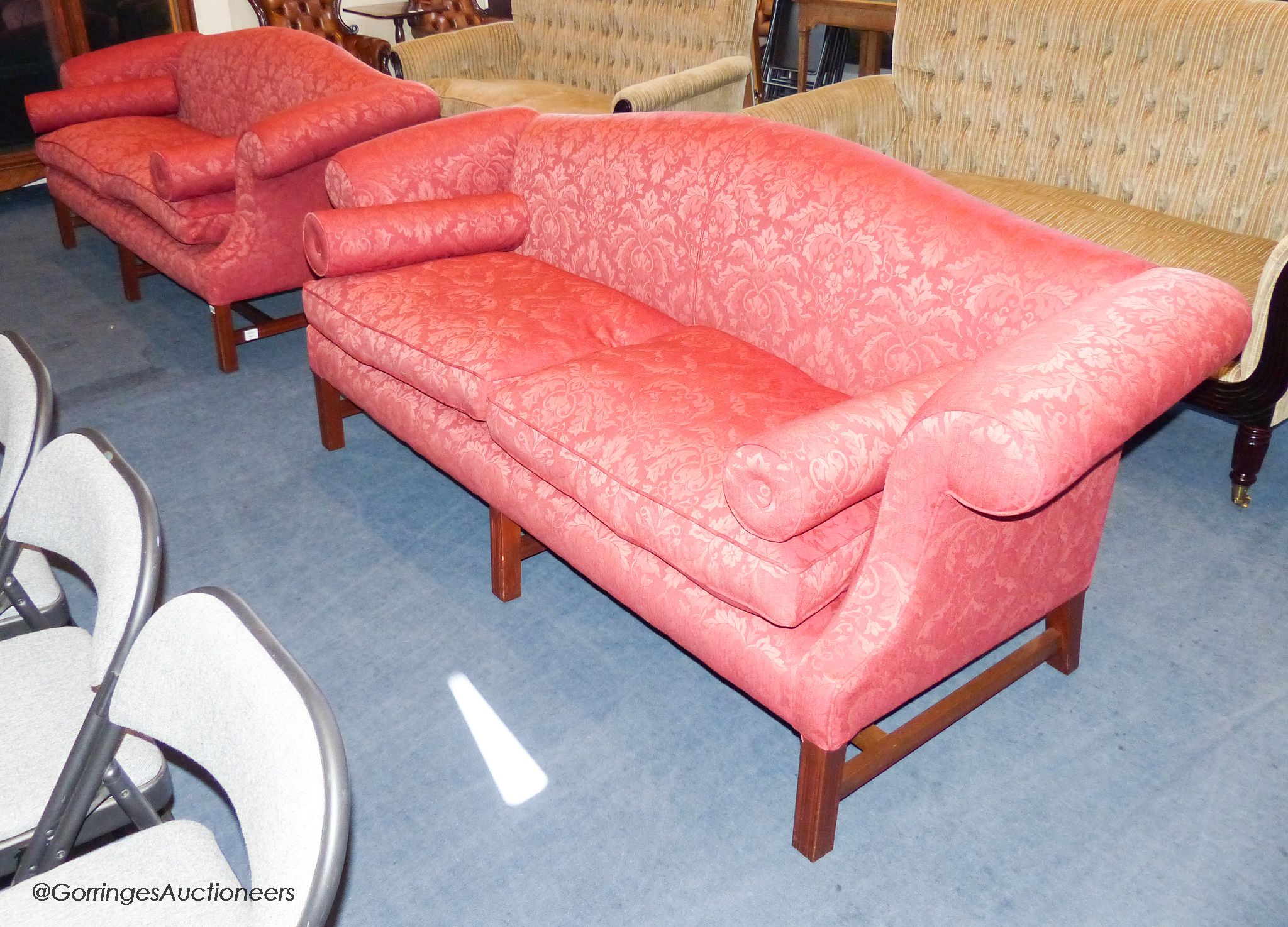 A pair of Hepplewhite style mahogany silk damask camel back sofas, 210 cm wide, with bolster cushions